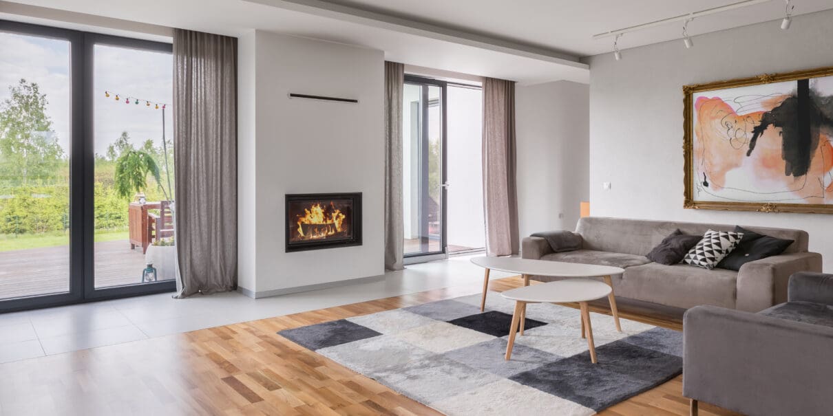 Spacious living room with floor panels, sofa and armchair